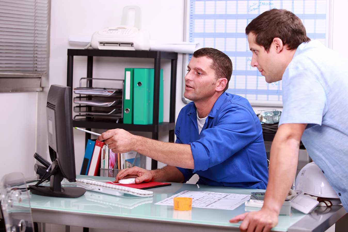 A businessman hold notebook and an engineer hold drawing plan shaking hands, successful in business negotiation deal , finishing up a project meeting at site construction. 